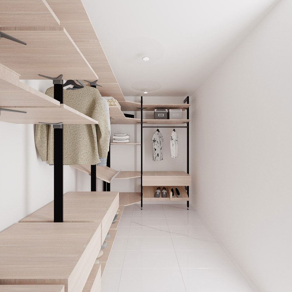 An interior view of a modern, minimalist walk-in closet with white walls, featuring built-in shelving units, hanging clothes, and storage bins.