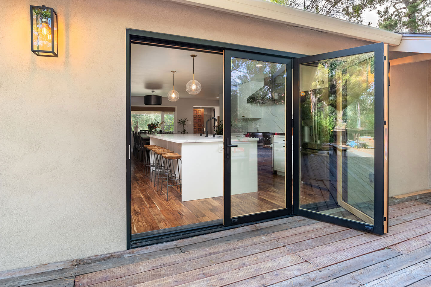 A modern outdoor living space with sliding glass doors.